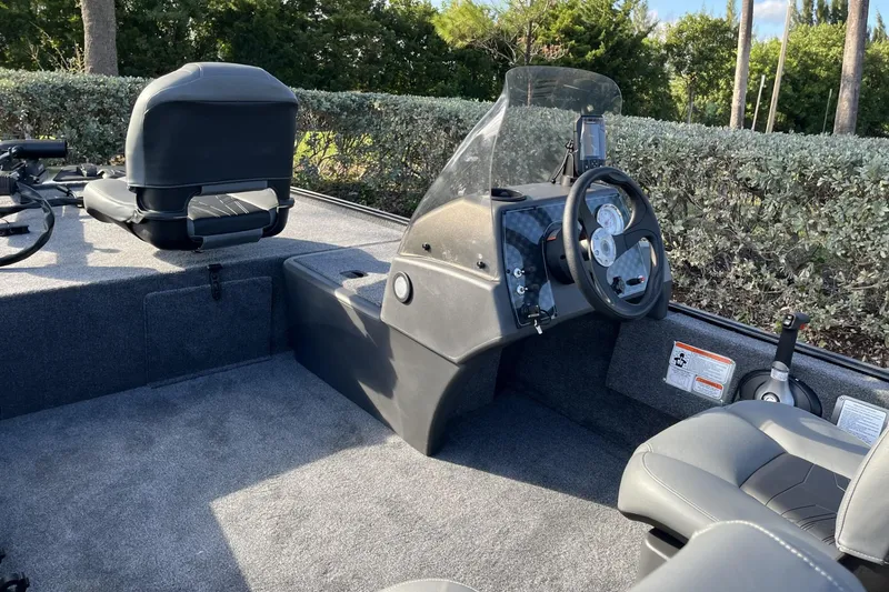 Slide: The Image of 2026 Tracker Bass Tracker Classic XL boat interior with steering console and seating. - 6