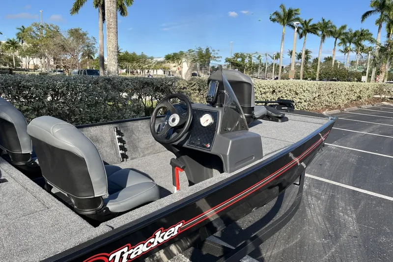 Slide: The Image of 2026 Tracker Bass Tracker Classic XL boat parked, featuring steering console and seating. - 8