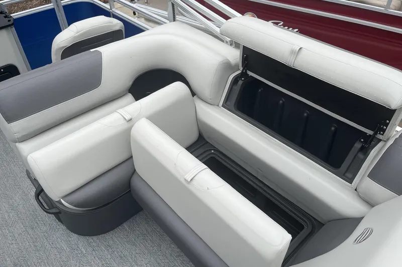 Slide: The Image of 2026 Sun Tracker Fishin' Barge 20 DLX boat seating with open storage compartments. - 103