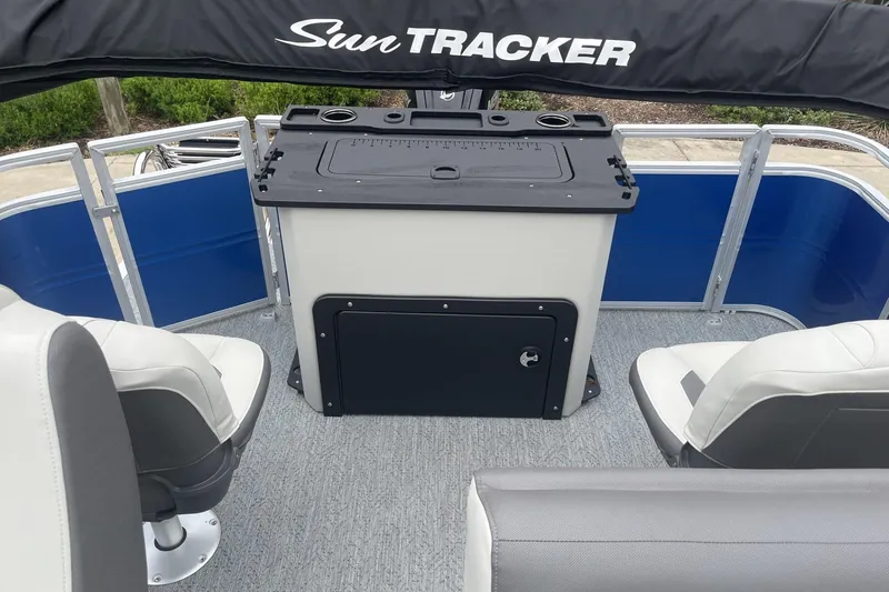 Slide: The Image of 2026 Sun Tracker Fishin' Barge 20 DLX interior with seating and storage. - 101