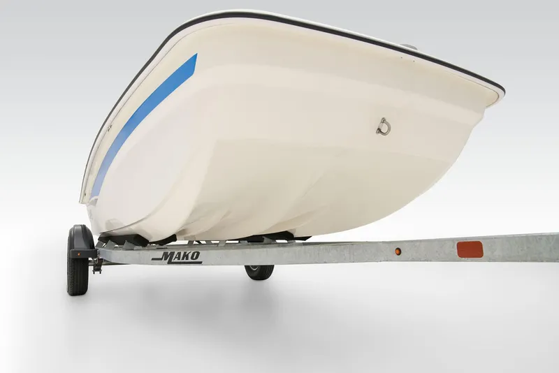 Slide: The Image of 2026 Mako Pro Skiff 15 CC with Mercury outboard motor, parked outdoors. - 11