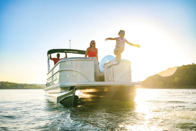 Slide: The Image of 2026 Sun Tracker Party Barge 20 DLX pontoon boat on trailer in snowy setting. - 2