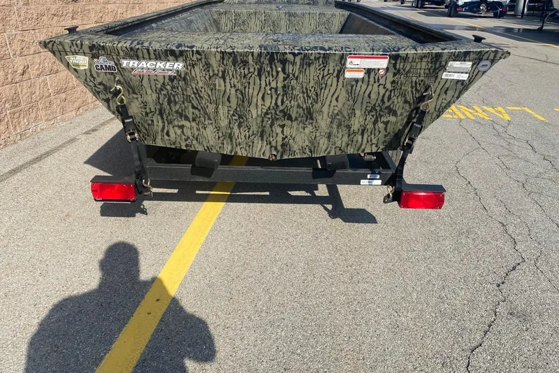 Slide: The Image of 2026 Tracker Grizzly 1648 Utility boat with camouflage design on a trailer. - 2