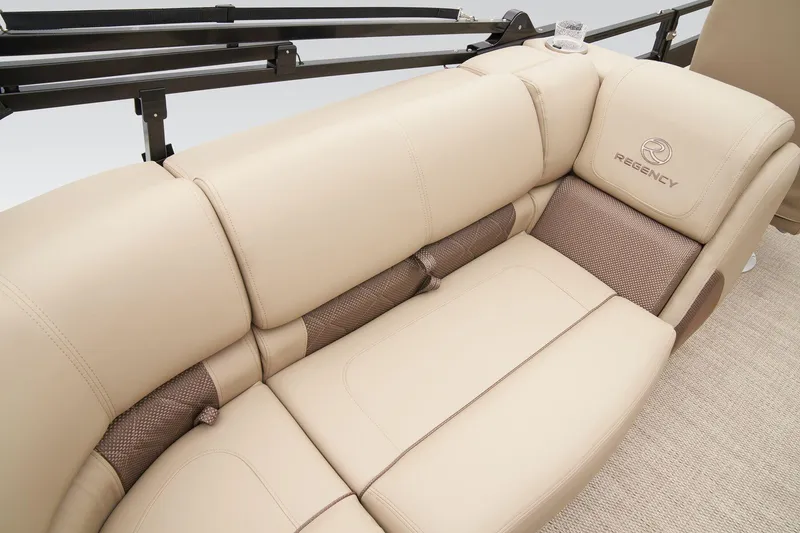 Slide: The Image of 2025 Regency 230 LE3 pontoon boat with canopy, parked in an industrial area. - 29