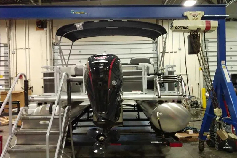 Slide: The Image of 2026 Sun Tracker Fishin' Barge 22 XP3 pontoon boat in a workshop setting. - 110