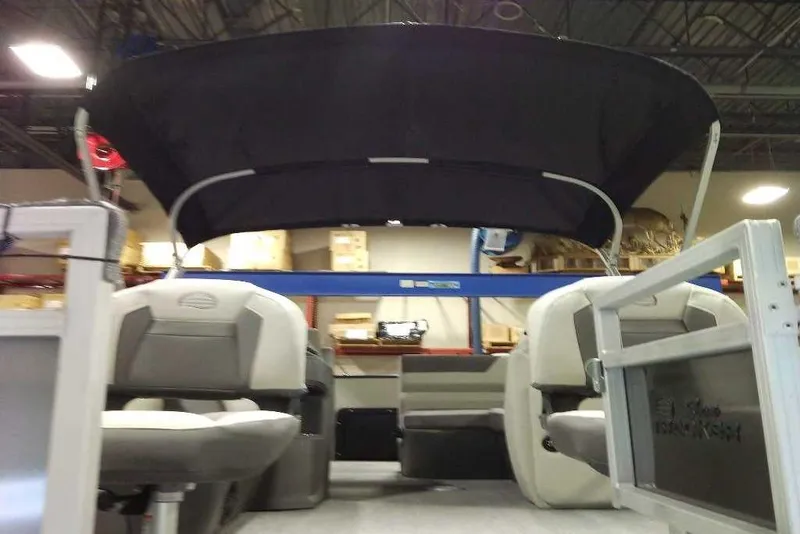 Slide: The Image of 2026 Sun Tracker Fishin' Barge 22 XP3 interior with canopy, showcasing seating and storage. - 112