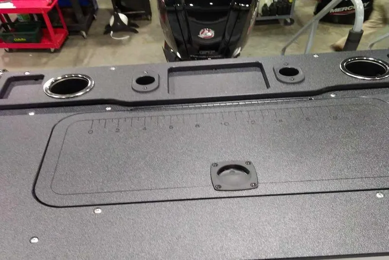 Slide: The Image of 2026 Sun Tracker Fishin' Barge 22 XP3 deck with cup holders and measurement markings. - 114