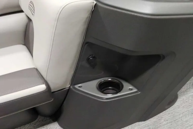 Slide: The Image of 2026 Sun Tracker Fishin' Barge 22 XP3 interior with cup holder and seating detail. - 118