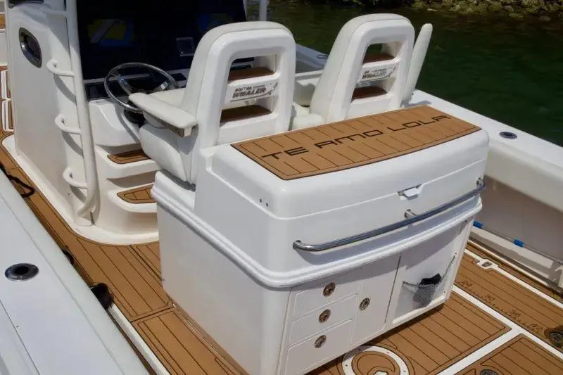 Slide: The Image of 2013 Boston Whaler 320 Outrage boat interior with dual seats and teak flooring. - 10