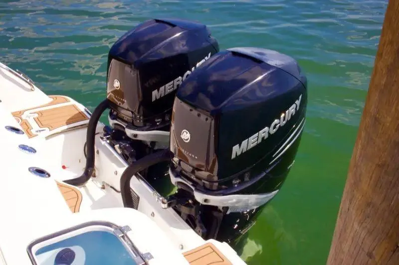 Slide: The Image of Twin Mercury outboard engines on a 2013 Boston Whaler 320 Outrage in clear water. - 4