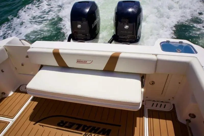 Slide: The Image of 2013 Boston Whaler 320 Outrage boat with twin Mercury engines and cushioned seating. - 5