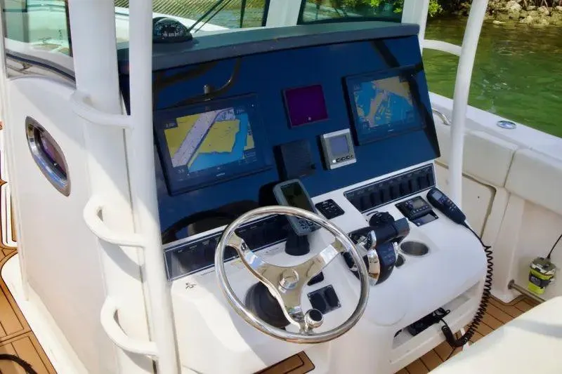 Slide: The Image of 2013 Boston Whaler 320 Outrage helm with navigation screens and controls. - 7
