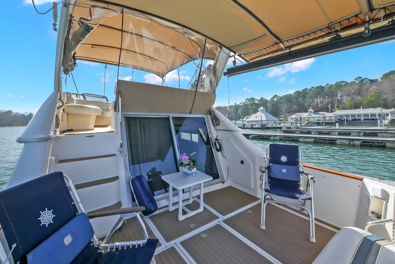 Slide: The Image of 1993 Sea Ray Express Bridge 350 on calm waters with seating area. - 12