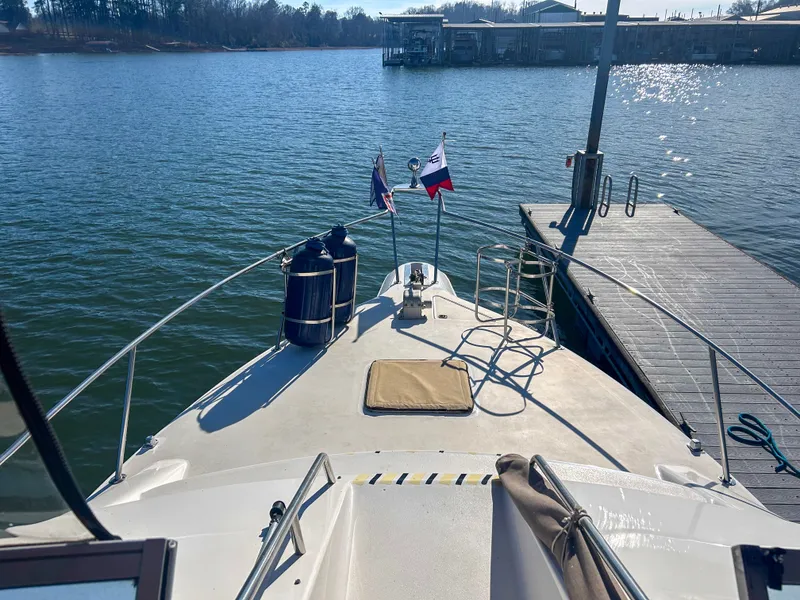 Slide: The Image of 1993 Sea Ray Express Bridge 350 docked by the water. - 18