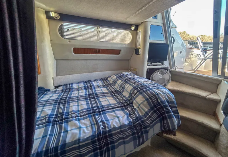 Slide: The Image of Interior of 1993 Sea Ray Express Bridge 350 with bed and window. - 28