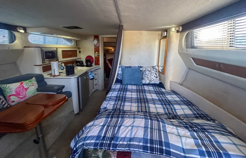 Slide: The Image of 1993 Sea Ray Express Bridge 350 interior with bed and kitchenette. - 31