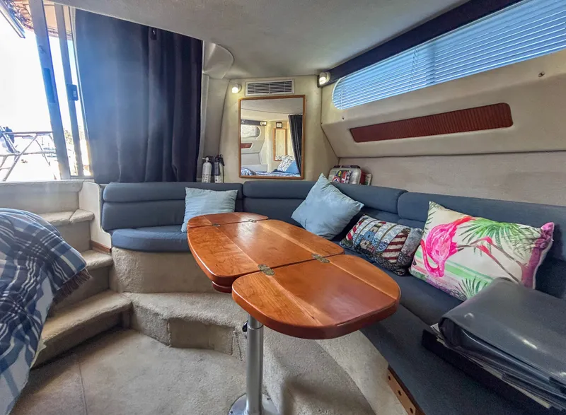 Slide: The Image of 1993 Sea Ray Express Bridge 350 interior with cozy seating area. - 33