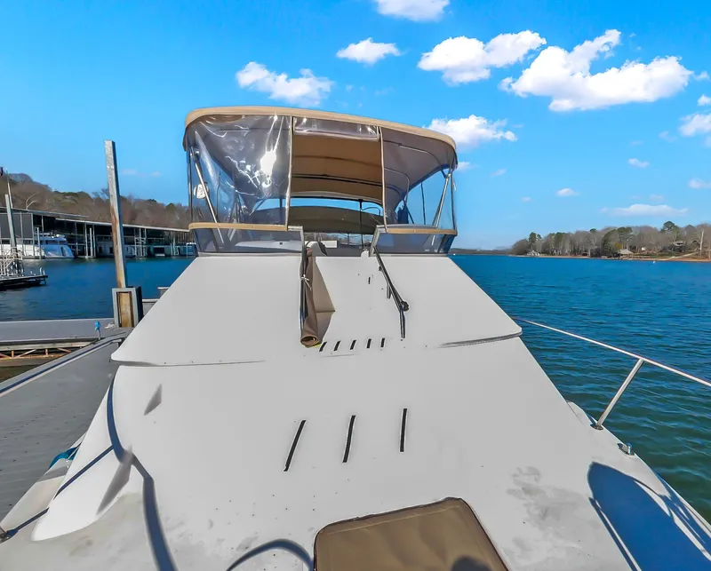 Slide: The Image of 1993 Sea Ray Express Bridge 350 on calm water under blue sky. - 44