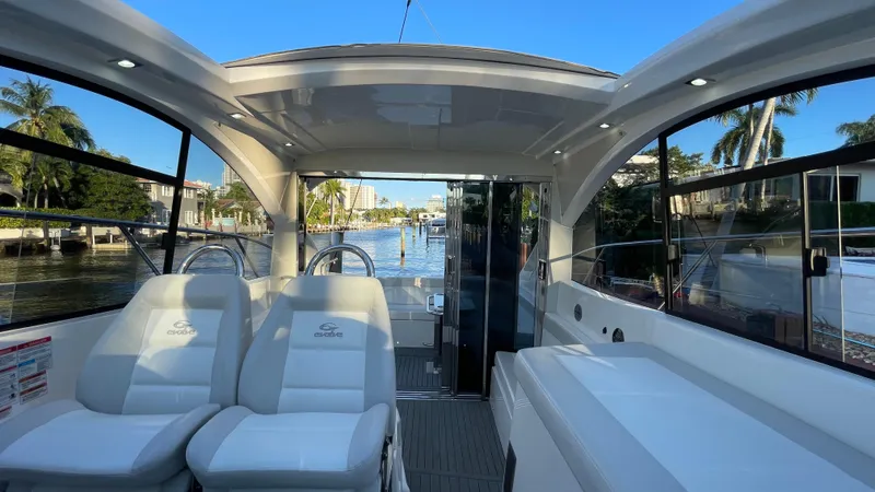 Slide: The Image of Interior view of 2022 Evolve 400HT yacht with luxurious seating and scenic waterway. - 15