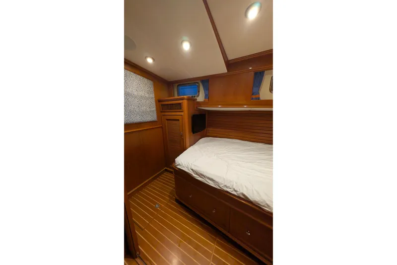 Slide: The Image of Luxurious cabin interior of 2004 Grand Banks 58 Eastbay FB yacht, featuring wooden finishes. - 10
