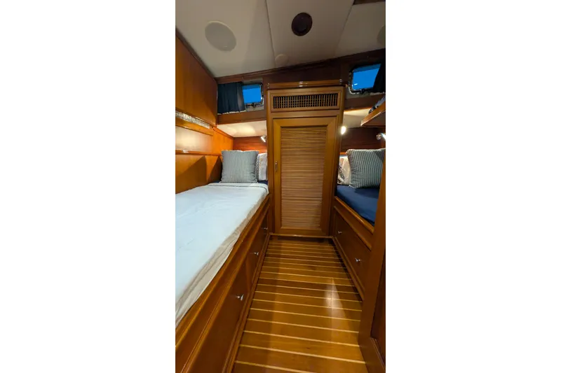Slide: The Image of Luxurious 2004 Grand Banks 58 Eastbay FB cabin with wooden interior and twin beds. - 11
