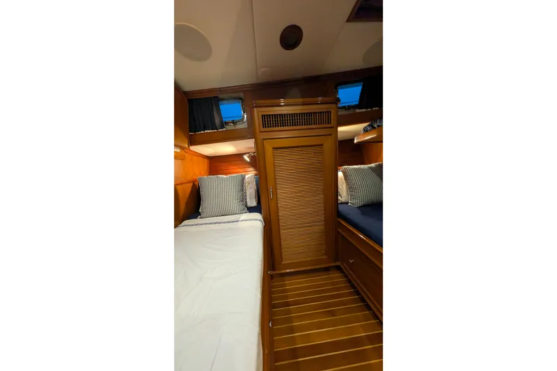 Slide: The Image of 2004 Grand Banks 58 Eastbay FB cabin with twin beds and wooden interior. - 14