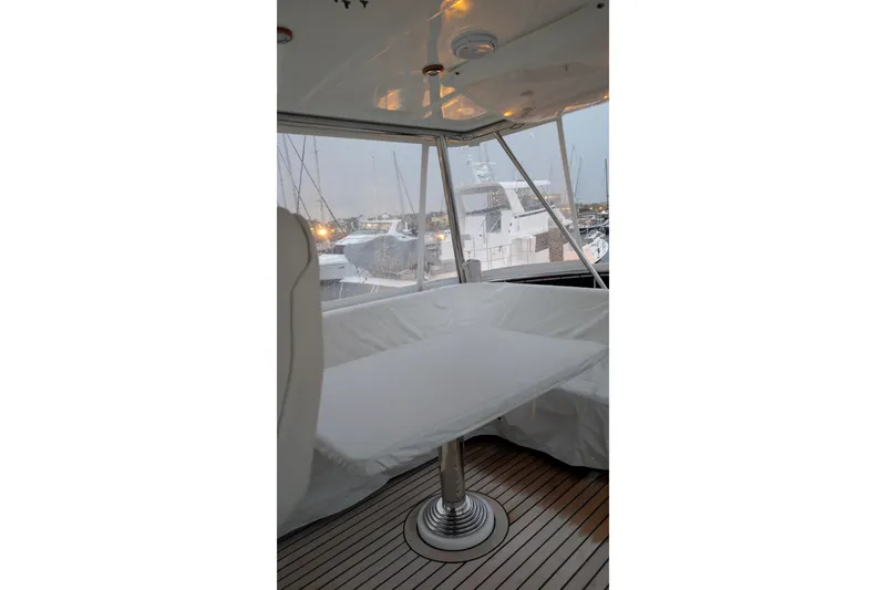 Slide: The Image of 2004 Grand Banks 58 Eastbay FB yacht interior with covered seating and table. - 18