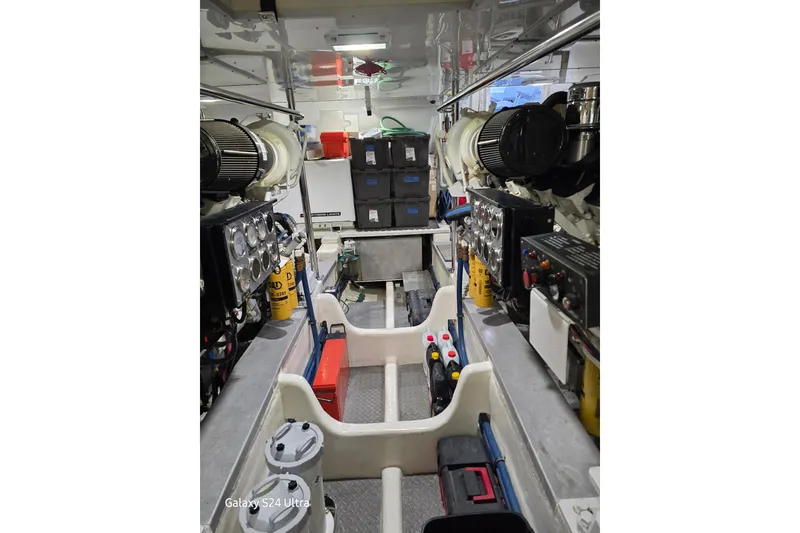 Slide: The Image of Engine room of 2004 Grand Banks 58 Eastbay FB yacht, showcasing machinery and equipment. - 22