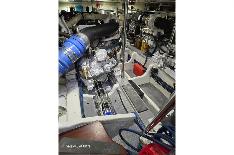 Slide: The Image of Engine room of 2004 Grand Banks 58 Eastbay FB yacht, showcasing mechanical components. - 24
