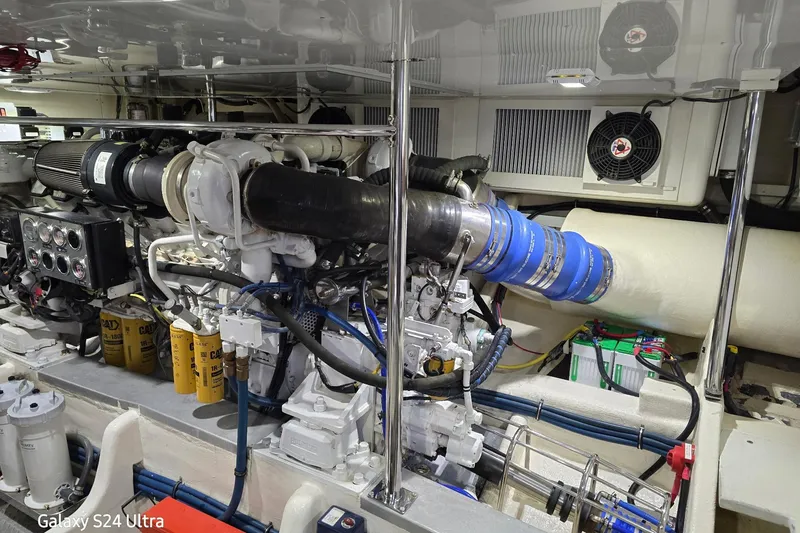 Slide: The Image of Engine room of 2004 Grand Banks 58 Eastbay FB yacht, featuring mechanical components and systems. - 25