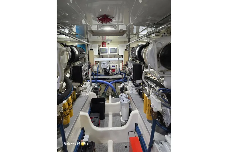 Slide: The Image of Engine room of 2004 Grand Banks 58 Eastbay FB yacht, showcasing machinery and equipment. - 27