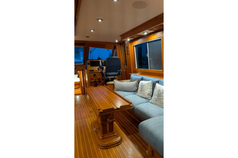 Slide: The Image of Luxurious interior of 2004 Grand Banks 58 Eastbay FB yacht with wooden finishes and plush seating. - 34