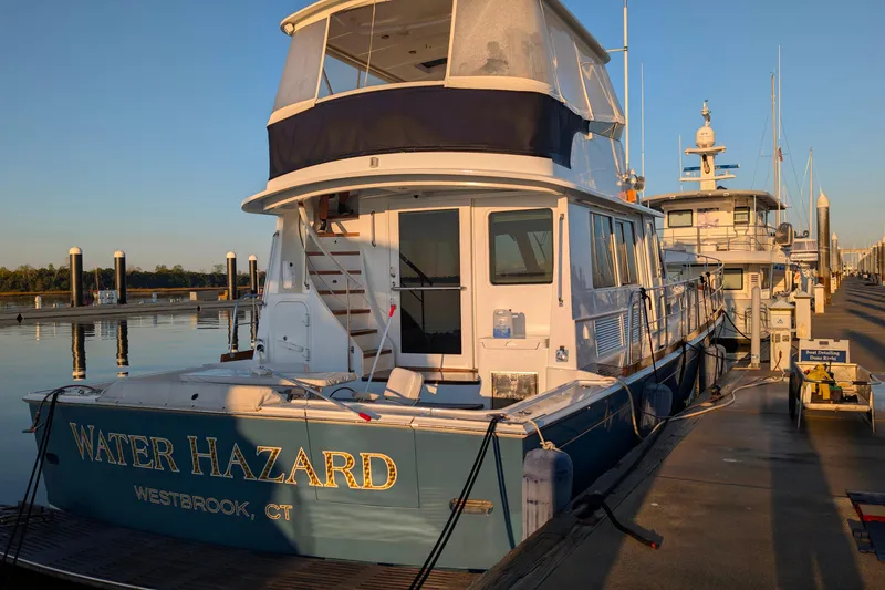 Slide: The Image of 2004 Grand Banks 58 Eastbay FB yacht docked at marina, sunset lighting. - 38
