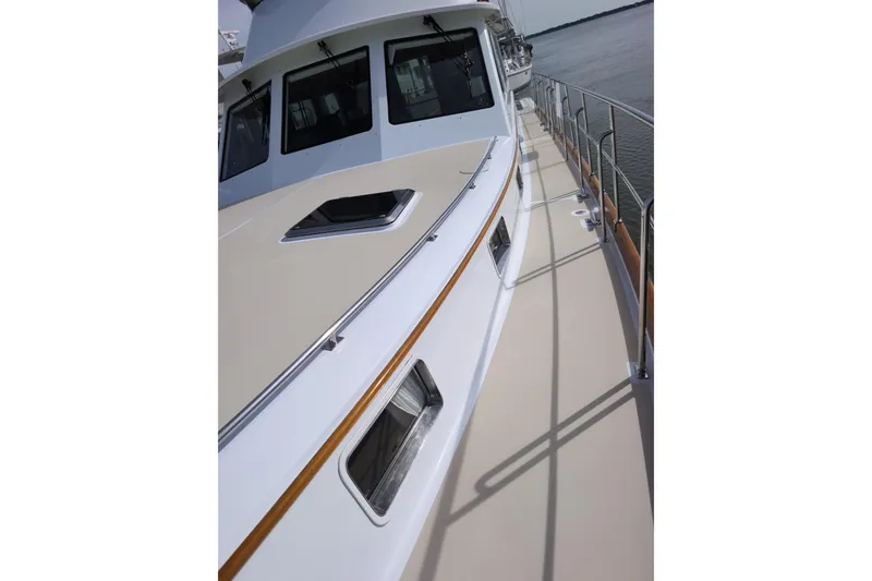 Slide: The Image of 2004 Grand Banks 58 Eastbay FB yacht deck with sleek design and railing. - 40