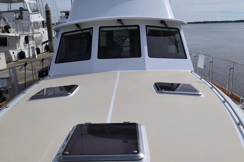 Slide: The Image of 2004 Grand Banks 58 Eastbay FB yacht deck with windows, docked at marina. - 41