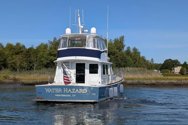 Slide: The Image of 2004 Grandbanks 58 Eastbay FB yacht "Water Hazard" cruising in a scenic waterway. - 6