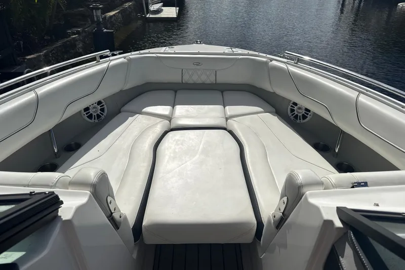 Slide: The Image of 2023 Regal LX6 boat interior with white leather seating and cup holders. - 6
