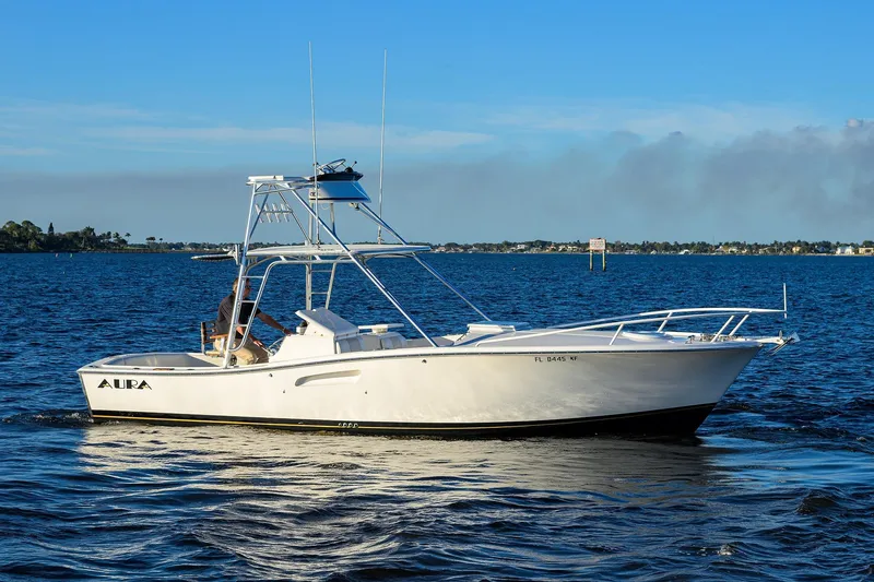 The Image of 1998 Aura 28 Tournament Series boat cruising on a calm blue sea. - 0