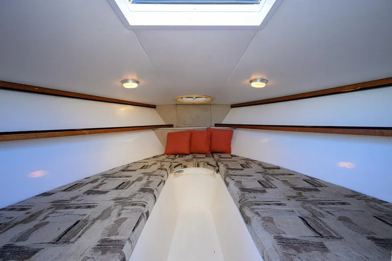 Slide: The Image of Interior cabin of 1998 Aura 28 Tournament Series boat with patterned cushions and skylight. - 1