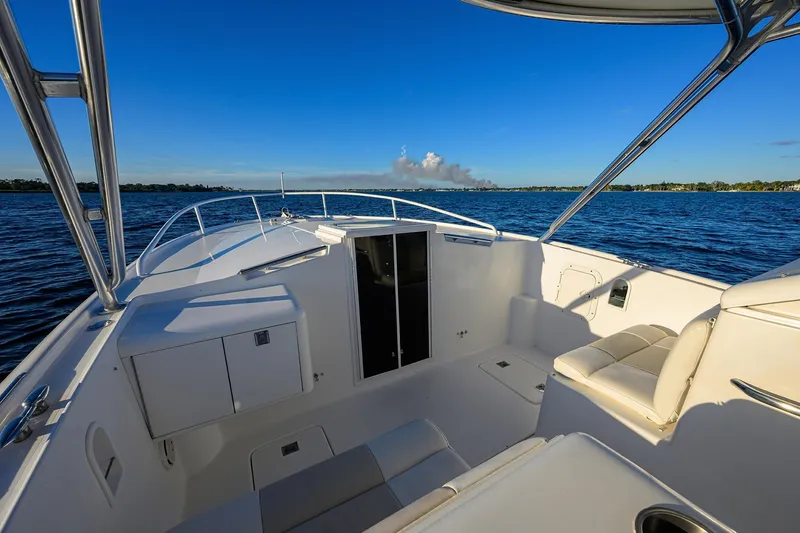 Slide: The Image of 1998 Aura 28 Tournament Series boat interior on calm blue water. - 14