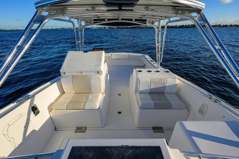 Slide: The Image of 1998 Aura 28 Tournament Series boat interior with seating, on calm blue water. - 15