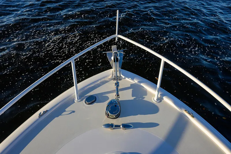 Slide: The Image of Bow of 1998 Aura 28 Tournament Series boat on calm water. - 16