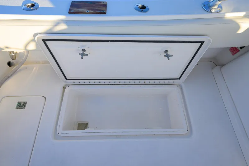 Slide: The Image of Open storage compartment on a 1998 Aura 28 Tournament Series boat deck. - 20