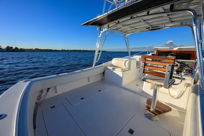 Slide: The Image of 1998 Aura 28 Tournament Series boat interior with helm, overlooking calm blue waters. - 24