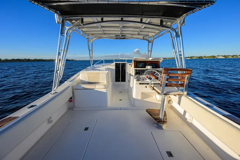 Slide: The Image of 1998 Aura 28 Tournament Series boat interior with helm, open deck, and ocean view. - 25