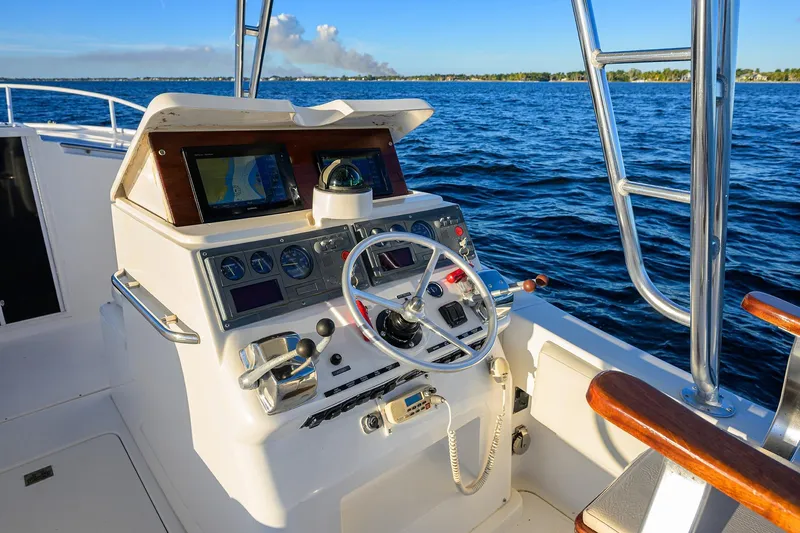 Slide: The Image of 1998 Aura 28 Tournament Series boat cockpit with steering wheel and navigation equipment. - 28
