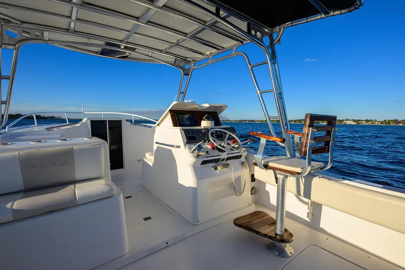 Slide: The Image of Interior view of 1998 Aura 28 Tournament Series boat with helm and seating, on open water. - 31