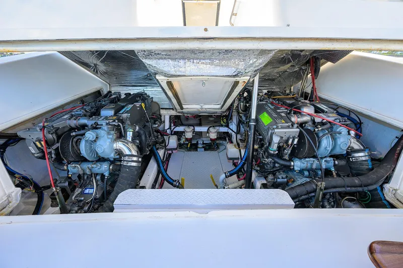 Slide: The Image of Engine compartment of a 1998 Aura 28 Tournament Series boat, showcasing dual engines. - 36