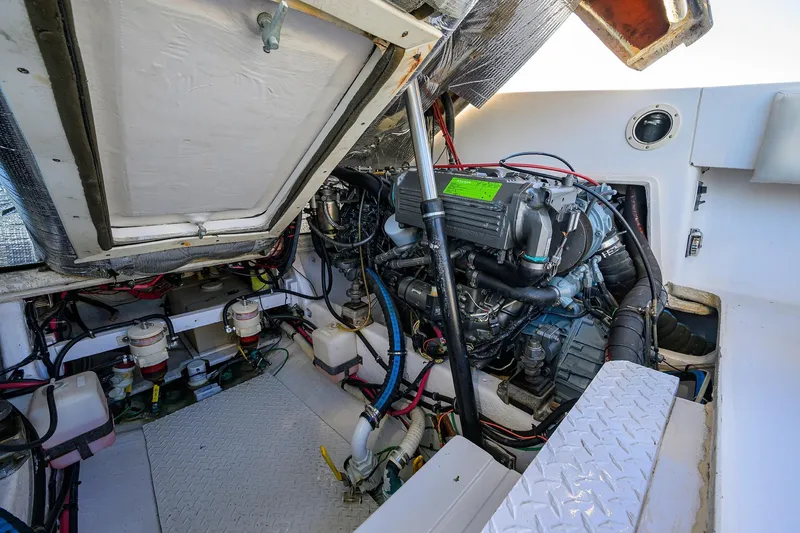 Slide: The Image of Engine compartment of a 1998 Aura 28 Tournament Series boat, showcasing detailed mechanical components. - 38