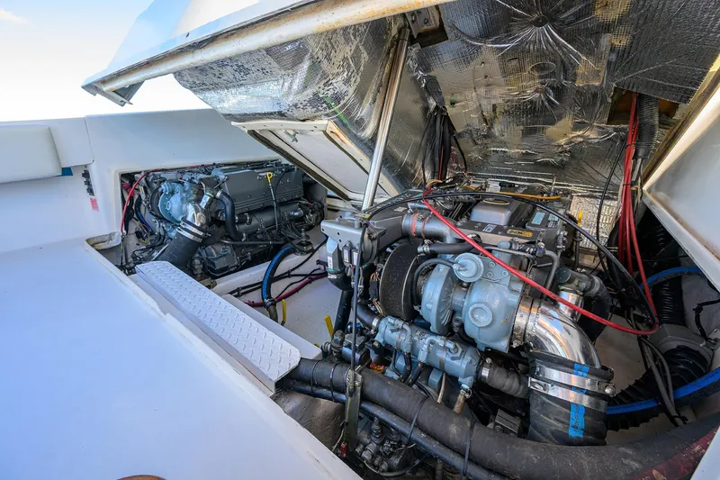 Slide: The Image of Engine compartment of 1998 Aura 28 Tournament Series boat, showcasing dual engines and mechanical components. - 39